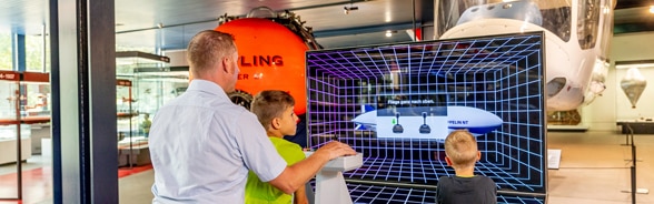 A boy and his dad operate the Zeppelin simulator. 