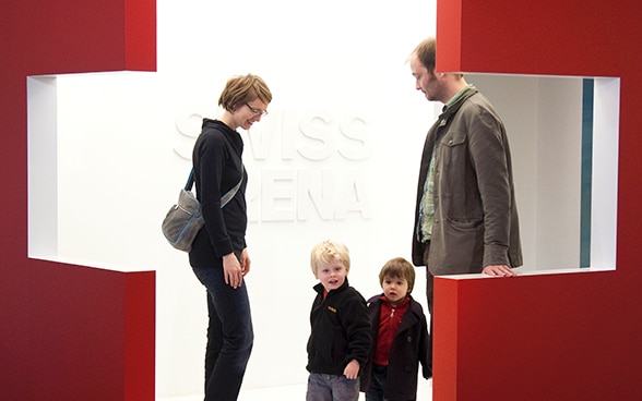 A family visiting an exhibition. 