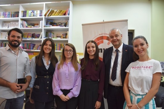 Staff from the National Youth Congress with Swiss Ambassador Adrian Maître at the presentation of youth migration study