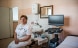A nurse sitting in a treatment room.
