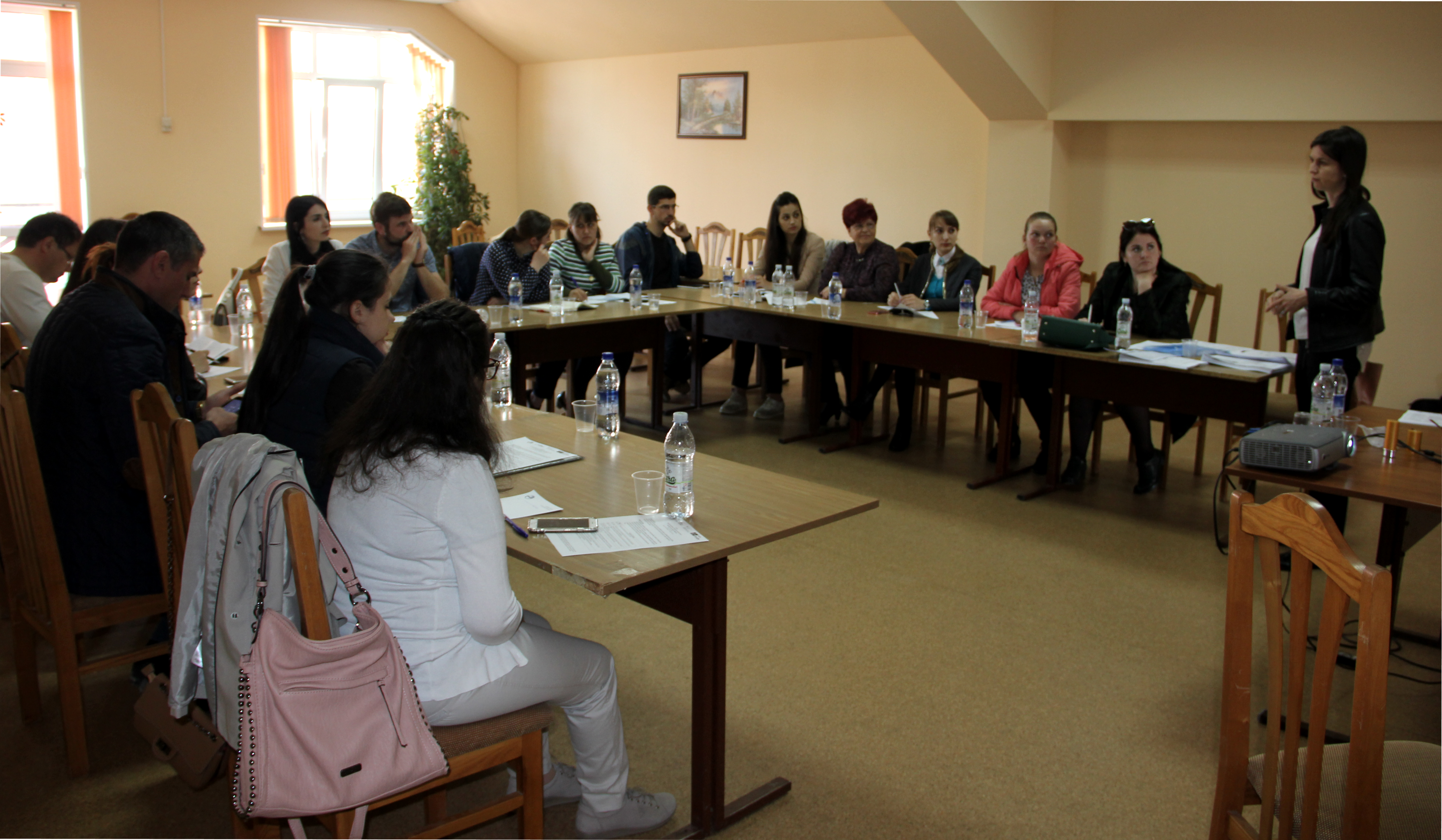 Women and men assembled in a room