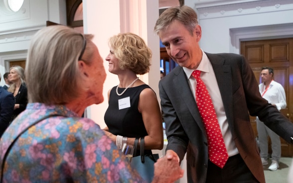 The Swiss Ambassador greeting a guest