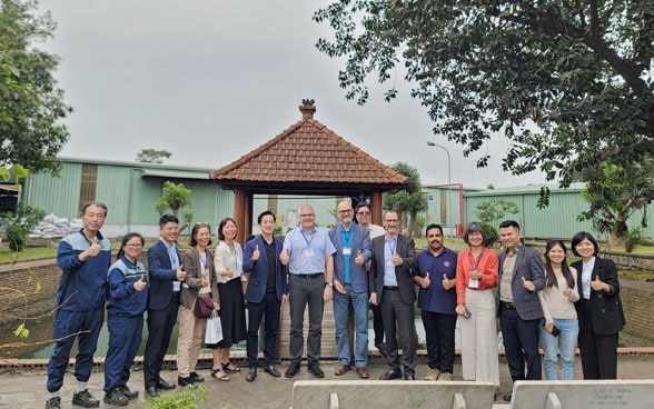 Mr. Christian Hofer, Director General of the Federal Office for Agriculture (FOAG) (in the middle, blue shirt) and the delegation at Son Ha Spice and Flavourings Co. Ltd