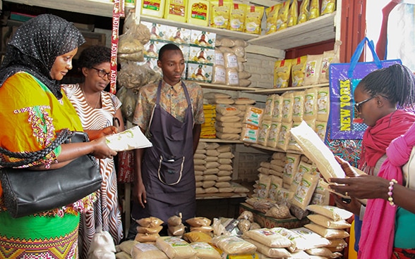Un’imprenditrice nel suo negozio di Bujumbura, insieme a un collaboratore e ad alcune clienti.