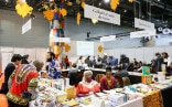 A stand at the African Book Fair where publishers present African literature for sale, and interested readers view the books on display. 
