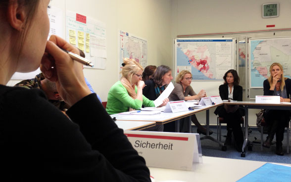 In Köniz, participants attend a meeting of the Swiss Humanitarian Aid's operations management for Ebola.