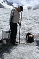 Dos hombres trabajando en un glaciar con sus equipos.