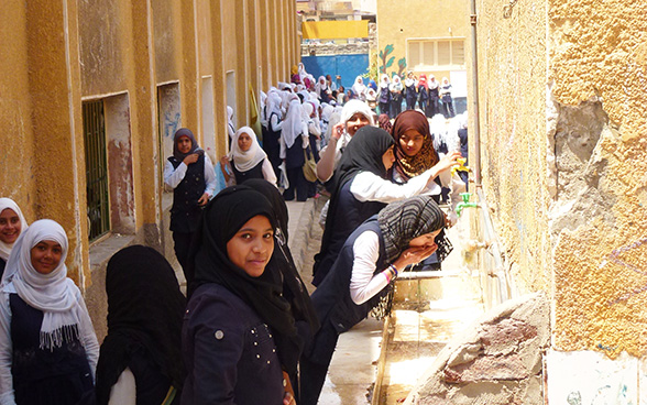 Girls at a secondary school in Aswan drink water from taps installed in the schoolyard.