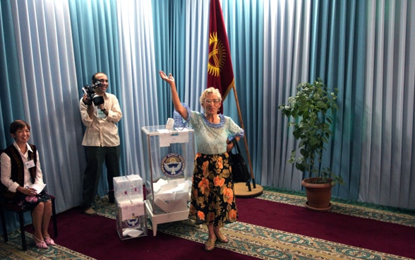 A Kyrgyz woman casting her ballot during national elections.