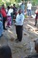 An instructor talks amidst a group of farmers standing in a circle