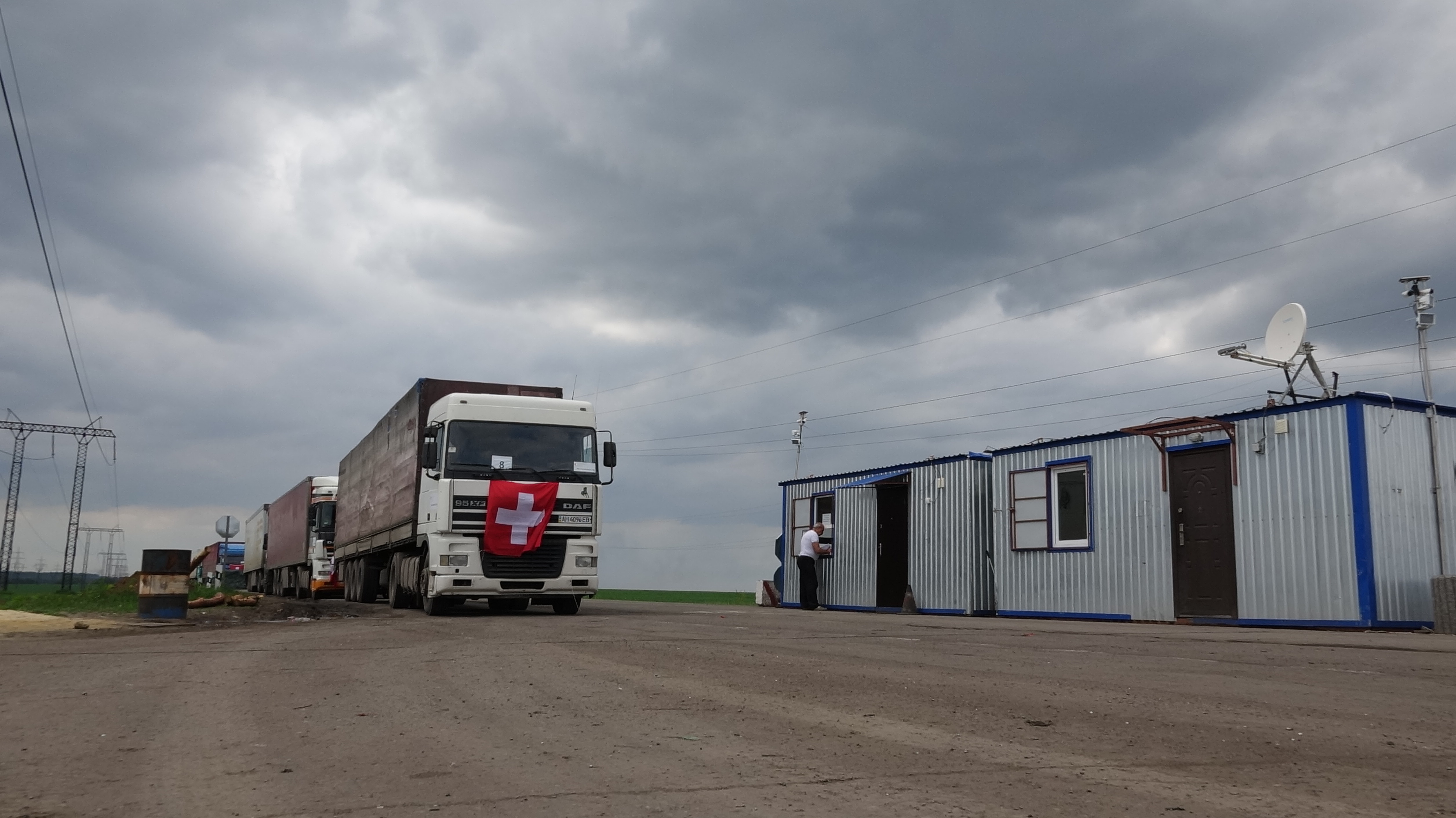 The lorries stop at a checkpoint. 