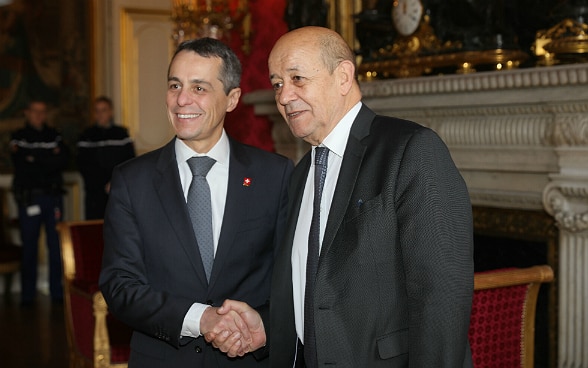 Ignazio Cassis serre la main du ministre français des Affaires étrangères Jean-Yves Le Drian à Paris.
