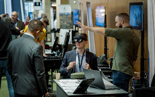 A conference participant tests a virtual reality headset.