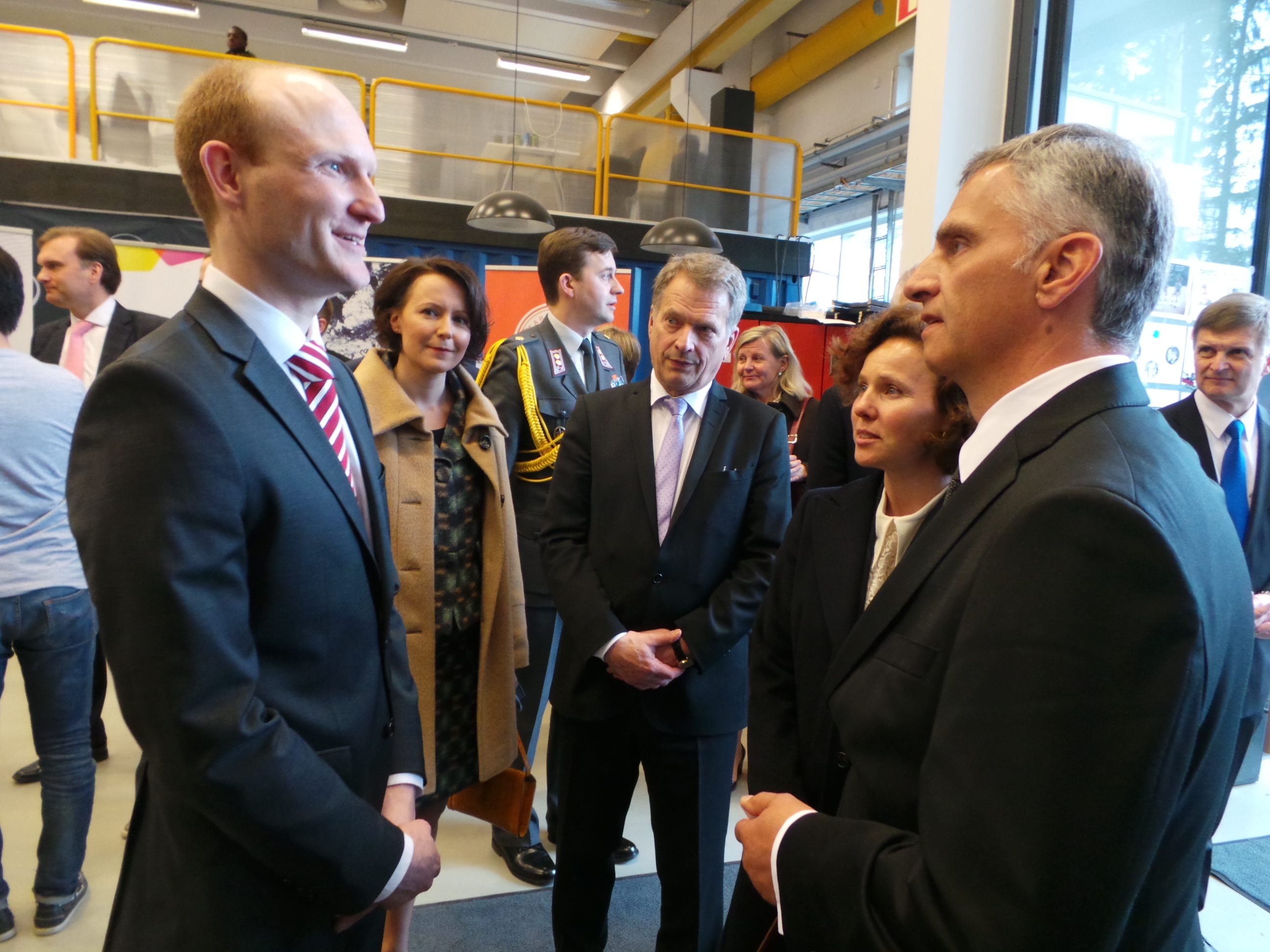 Didier Burkhalter et Sauli Niinistö en compagnie de leurs épouses à l’Université de Helsinki. Ils s’entretiennent avec un chercheur suisse.