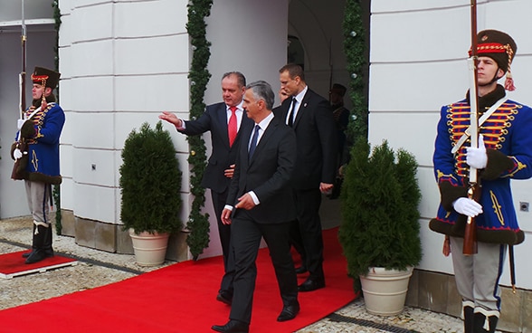 The President of the Swiss Confederation, Didier Burkhalter, talking with the President of the Slovak Republic, Andrej Kiska, in front of the presidential palace in Bratislava.