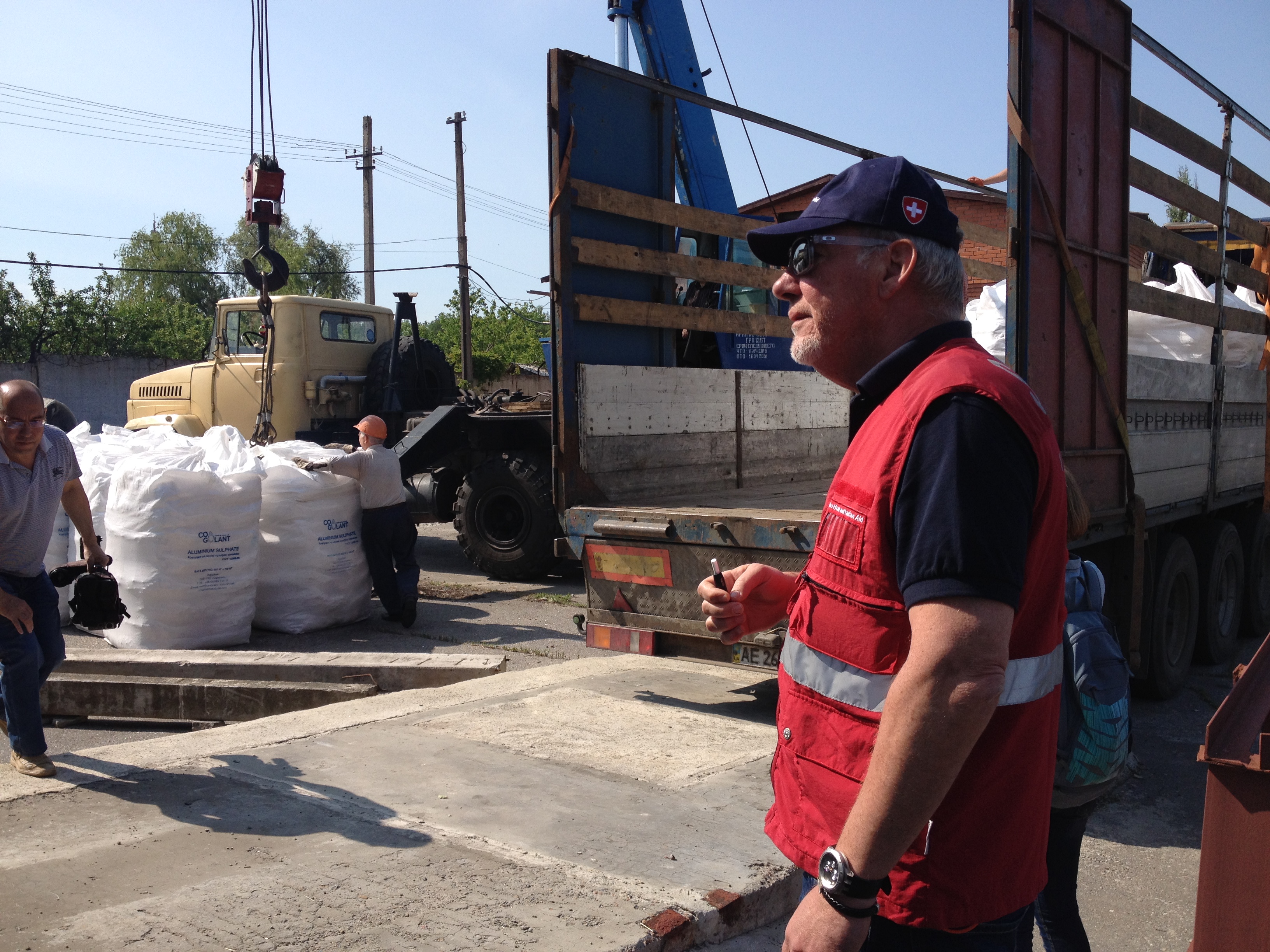 A lorry in front of a local branch of Voda Donbas water company in Krasnoarmiysk. People are standing around the vehicle.