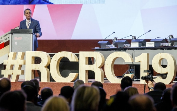 Swiss Foreign Minister Ignazio Cassis delivers his statement, during the opening ceremony of the 33rd International Conference of the Red Cross and Red Crescent, in Geneva.