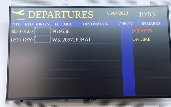 On the departure screen, the Goa-Dubai flight is announced on time. 