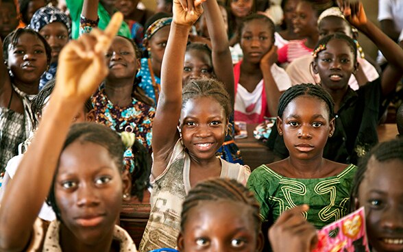 Young Africans take part in school lessons.