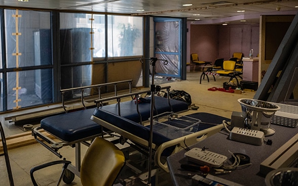 View into a hospital room, where the windows are taped with plastic.