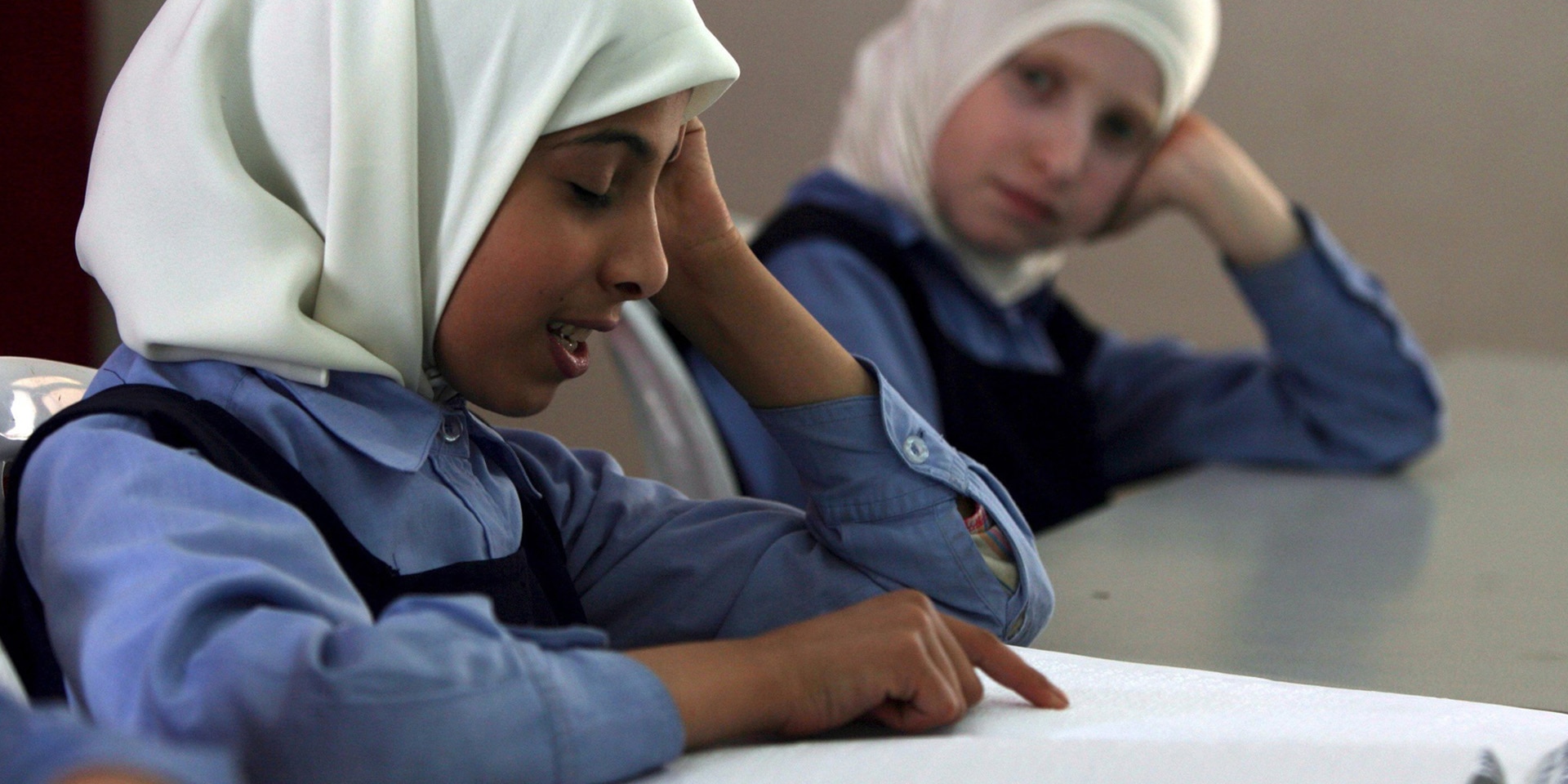 Ein blindes Mädchen liest in Gaza-Stadt ein Buch in Braille-Schrift.