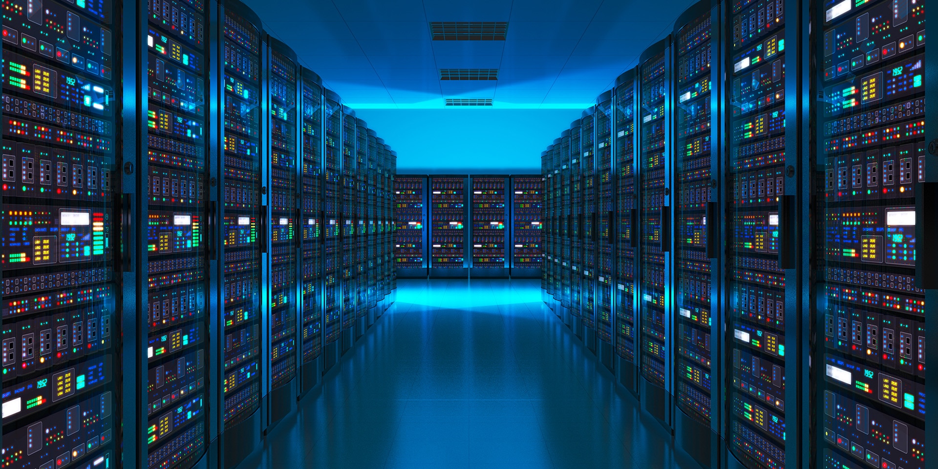 We see a darkened room with a blue glow containing rows of servers on which digital data is stored.