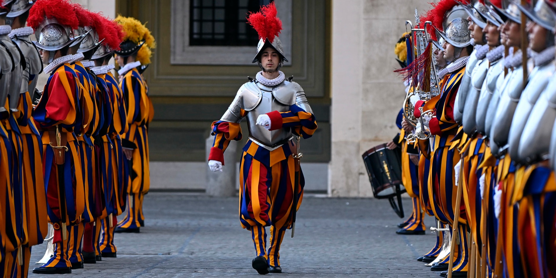 A guard marches during the swearing-in ceremony, his fellow soldiers lined up on either side of him.