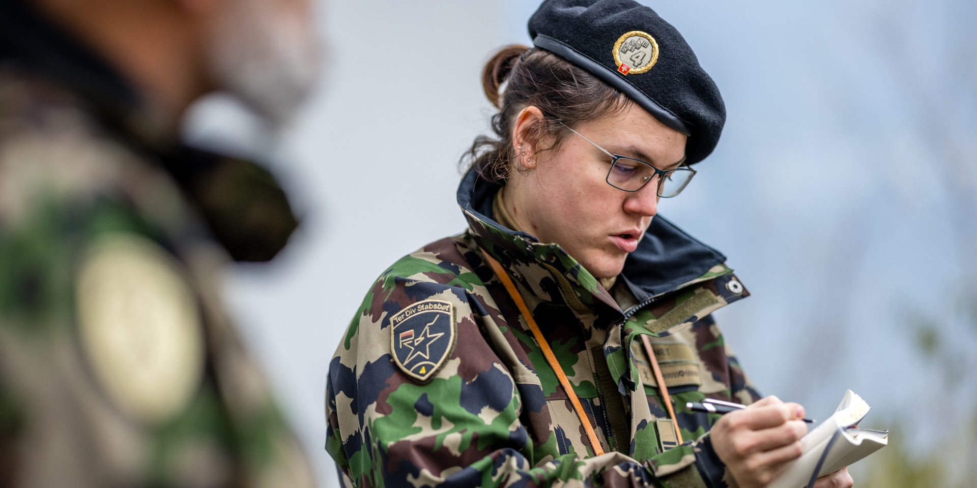 Two members of the army during an exercise in the field.