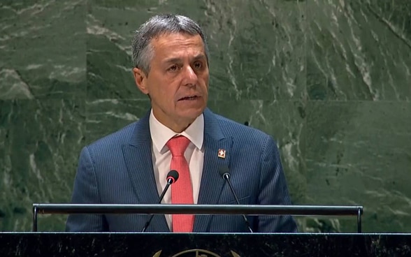 President Ignazio Cassis speaks at a lectern.