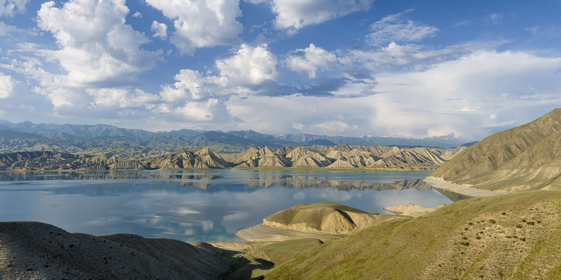 Meander of the Saray Yuek River, Kazakhstan, bordered by dry land and bushes.