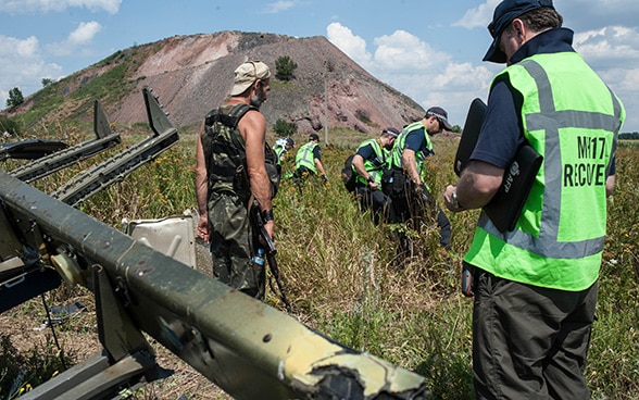 International investigators working around the remains of the Malaysia Airlines' aircraft that crashed in eastern Ukraine in summer 2014