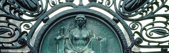 Image of the statue of Justice on the gate of the Peace Palace in The Hague