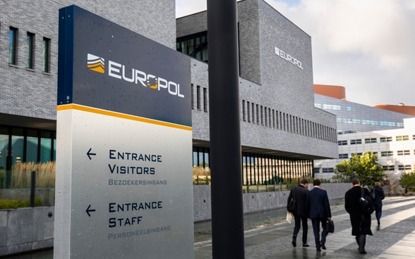 Passers-by in front of Europol headquarters in The Hague.