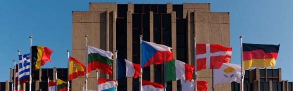 Flags of the EU member states flutter in the wind outside the European Court of Auditors building in Brussels.