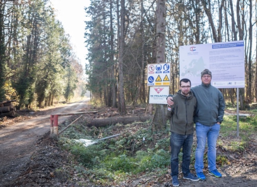 Two mine clearers in front of signs