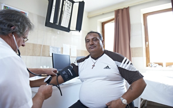 A family doctor taking a patient's pulse.